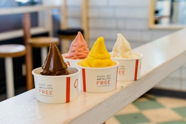 four assorted flavor of ice cream on white wooden table