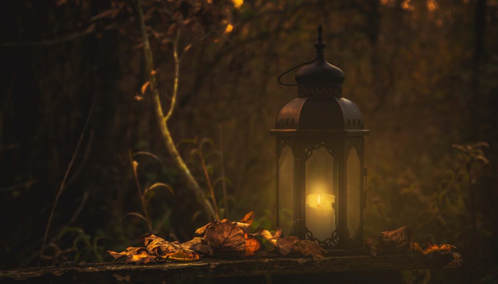 yellow pillar candle in black lantern
