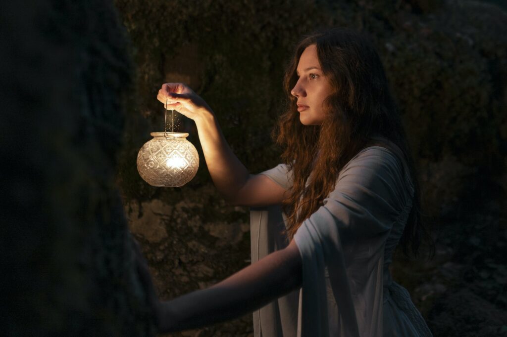 a woman holding a light in her hand