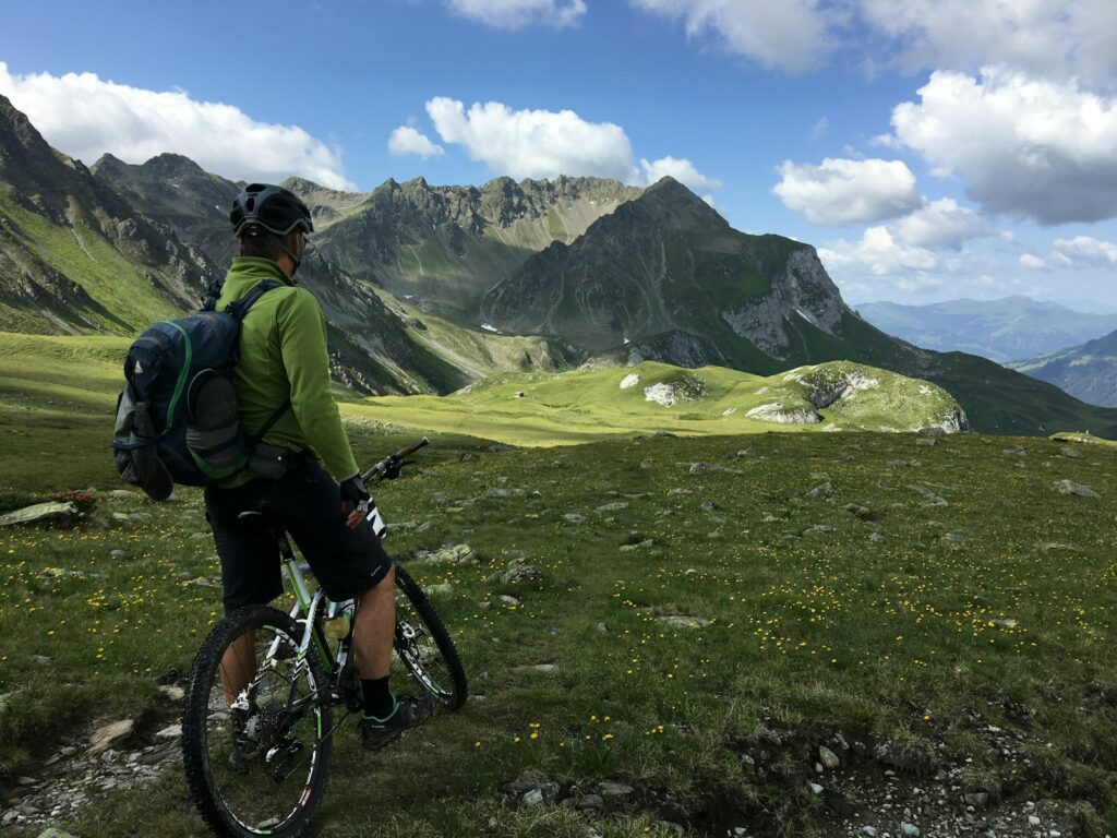 man riding bicycle on top of mountain